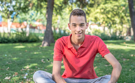 Smiling young man in the park の写真素材