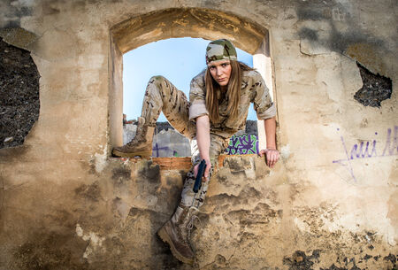 Spanish military girl jumping a window with gunの写真素材