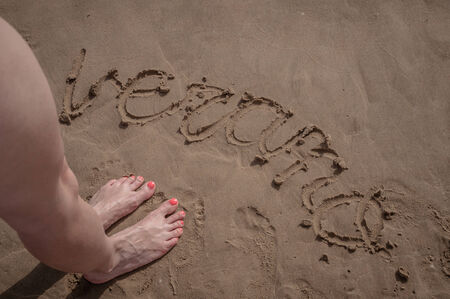 Word verano written on sand in the beach of Gandia, Spainの写真素材
