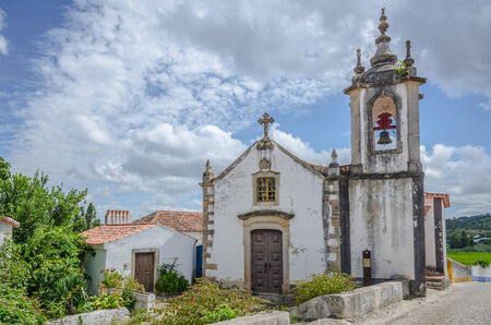 Church in Obidos, Portugal, on cloudy skyの写真素材
