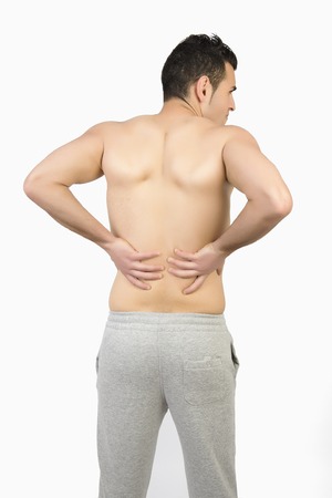 Muscular man with muscle pain on white backgroundの写真素材
