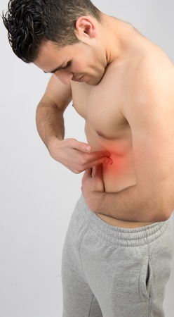 Muscular man with muscle pain on white backgroundの写真素材