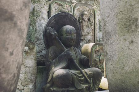 Small Buddha statue of rock in Japanの写真素材