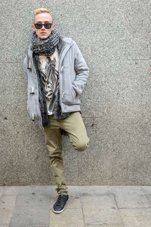 Portrait of young beautiful fashionable man in the streetの写真素材
