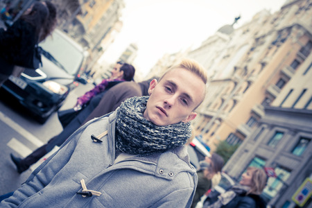 Portrait of young beautiful fashionable man in the streetの写真素材