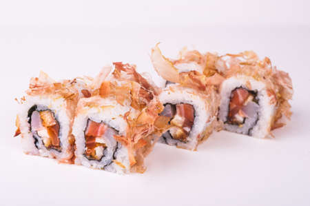 salmon sushi roll in tuna flakes  isolated on white backgroundの写真素材