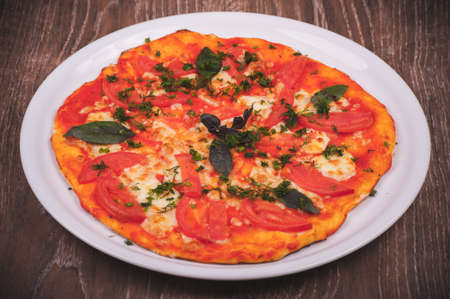 hand made pizza margarita on white plateの写真素材