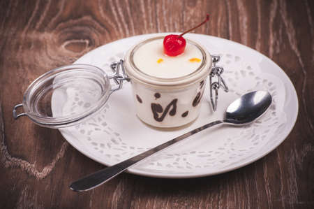 cream and chocolate desert in jar  with spoonの写真素材