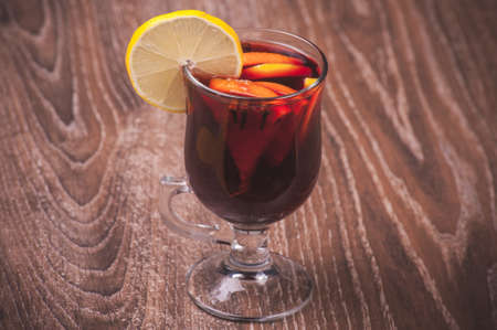 red mulled wine in glass with orangeの写真素材