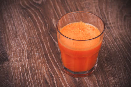 freshly squeezed orange carrot juice in glassの写真素材