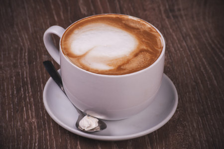 coffee cappuccino cup with milk foam with spoon