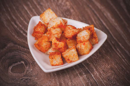 golden fried paprica croutons served in bowlの写真素材