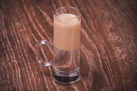 Layered alcohol shot cocktail with baileys and vodkaの写真素材