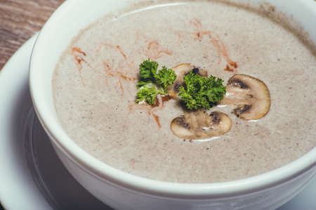 tasty mushroom cream soup in white bowlの写真素材