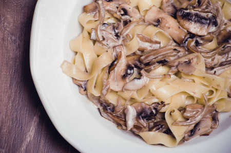 pasta with mushroom creamy sauce on white plateの写真素材