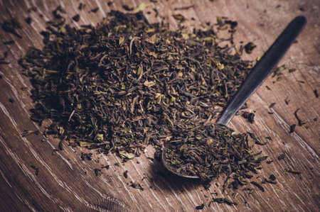 black and green dried leafs  on spoonの写真素材
