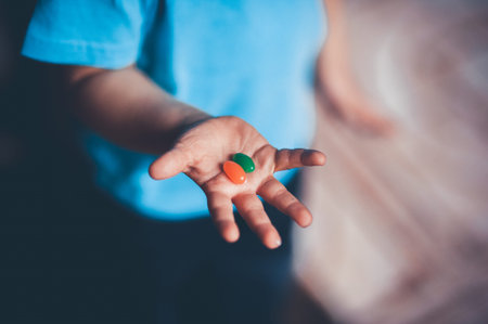 child holds candies on his open hand