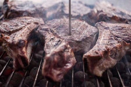 six big beef steaks on bone grilled  barbecue with thermometerの写真素材