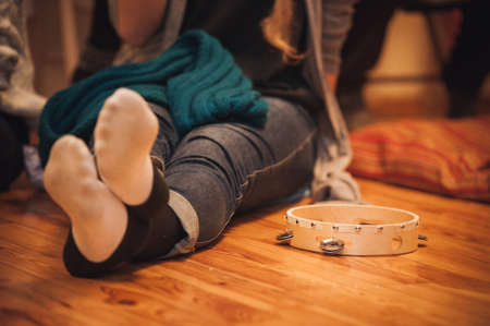 Young woman with tambourine next to her no faceの写真素材