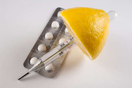 Lemon, pills ,  vitamins with thermometer isolated  on white backgroundの写真素材