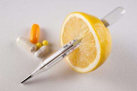 Lemon, pills ,  vitamins with thermometer isolated  on white backgroundの写真素材