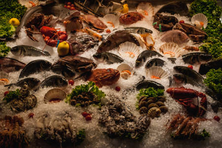 fresh seafood displayed on ice in front of restaurantの写真素材