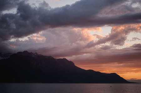 Cloudy sky orange sunset over the  lakeの写真素材