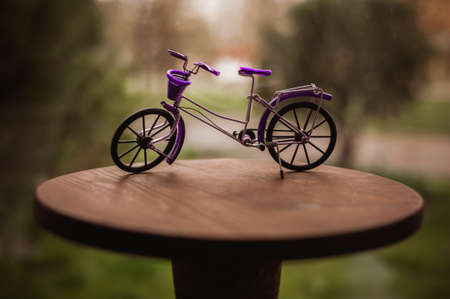 purple bicycle toy for decor on tableの写真素材