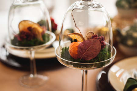 autumn decor with dry flowers and oranges in glassの写真素材