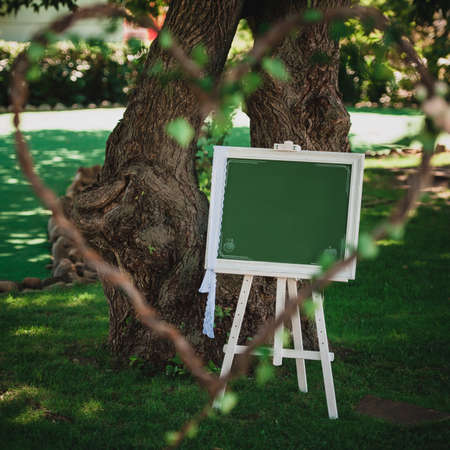 White wedding wooden empty  sign with ribbons in gardenの写真素材