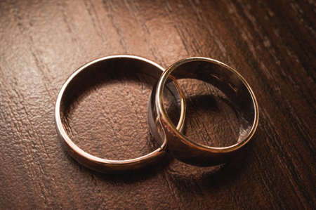 Two wedding rings on a wooden backgroundの写真素材