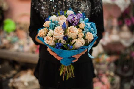 close up photo of young woman holding bouquet of flowers.