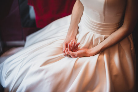 A close up on a bride hand on legsの写真素材