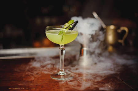 Green alcohol cocktail with lime in barの写真素材