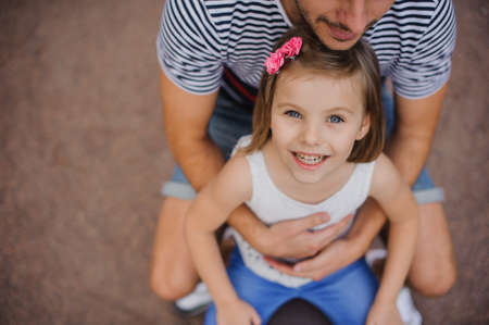 Happy father and daughter in a park a top viewの写真素材