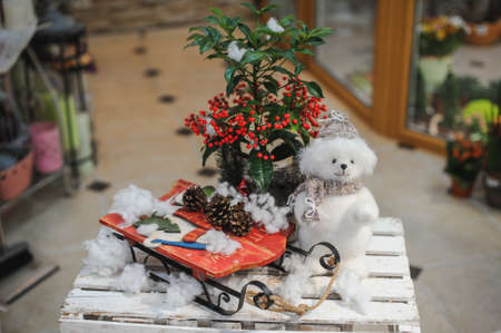 Christmas composition with sleigh, pinecone and decoration on snow.の写真素材