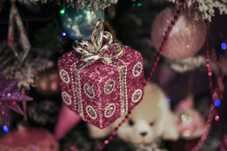 Beautiful color christmas decorations hanging on christmas tree with shiny glareの写真素材
