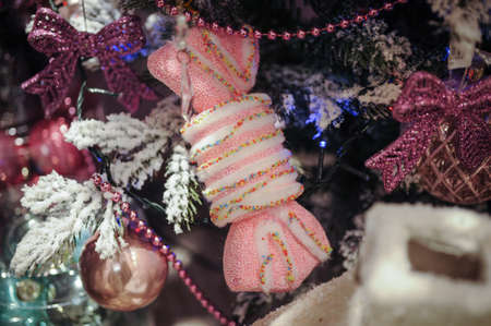Beautiful color christmas decorations hanging on christmas tree with shiny glareの写真素材