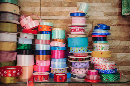 Various colors ribbon bobbins on top of each otherの写真素材