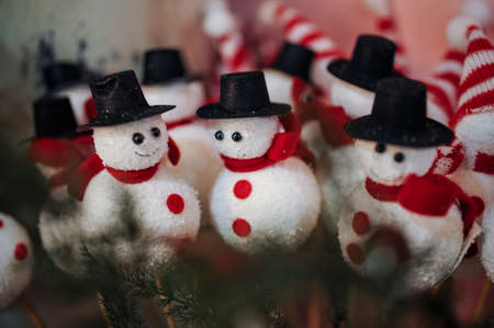 a lot of snowmen with hat and scarveの写真素材