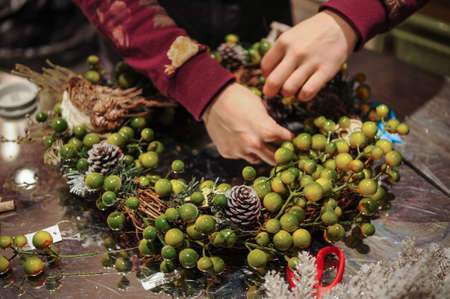 Florist at work: woman making door wreathの写真素材