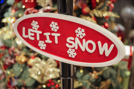 Close up of Christmas decorations. Red sign let it snowの写真素材