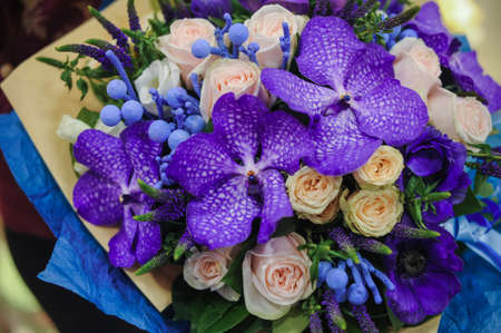 colorful wedding bouquet with beautiful purple orchid in handsの写真素材