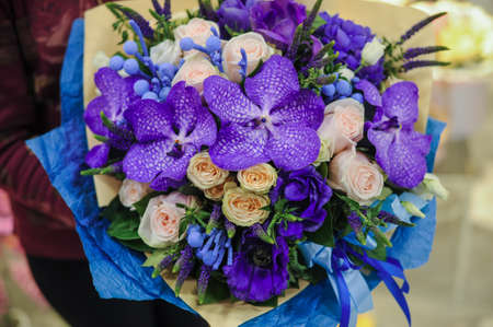 colorful wedding bouquet with beautiful purple orchid in handsの写真素材