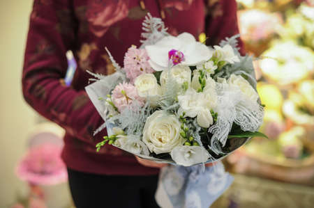 big white bouquet with huge orchids in handsの写真素材