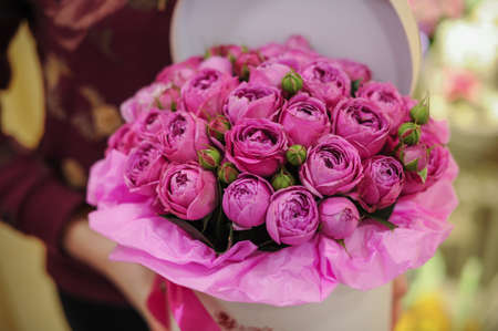 big bright pink roses bouquet in round box with lidの写真素材