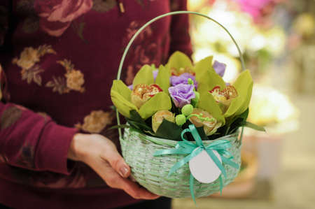 Basket with green orchid flowers. in handsの写真素材