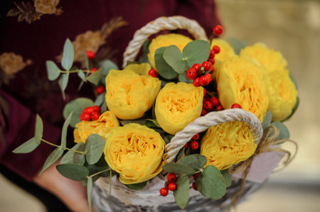 beautiful bouquet of yellow flower in basket  in hands