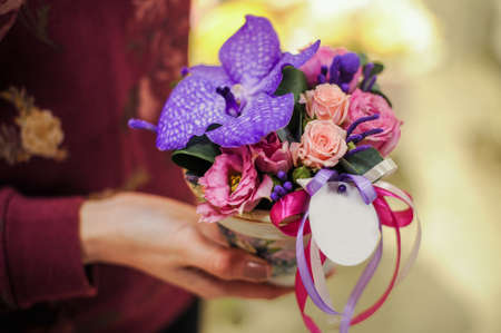 Small bouquet of pink and purple flowers  in handsの写真素材