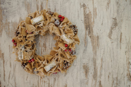 Christmas wreath made of canvas  on a wooden background